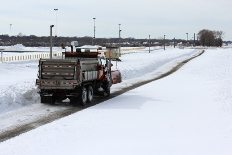 MnDOT snowplow driver John Hokkanen makes a test run at the research site at Canterbury Park.  (Photo by Nick Busse)
