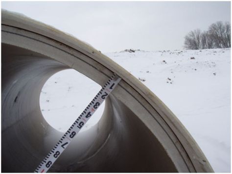 Sliplining, a common culvert rehabilitation method, involves inserting a fiberglass pipe liner (shown) or other material into a deteriorated culvert.