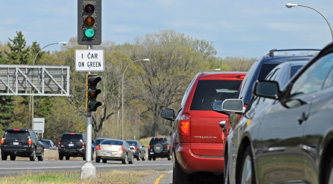 Cars line up at a ramp meter.