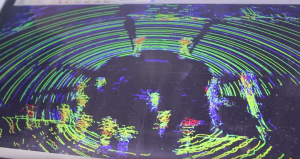 Event attendees move around the sedan to see how the LiDAR sensor views them. (Photo by Micheal Foley, MnDOT)