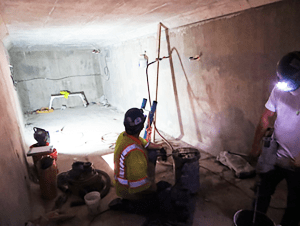 Workers repairing grout voids
