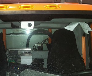 Camera mounted on the ceiling of a MnDOT snowplow cab.