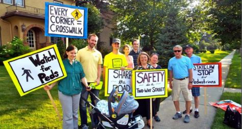 A group of people holding signs with traffic safety messages