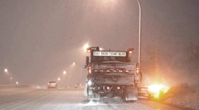 snow plow on icy road