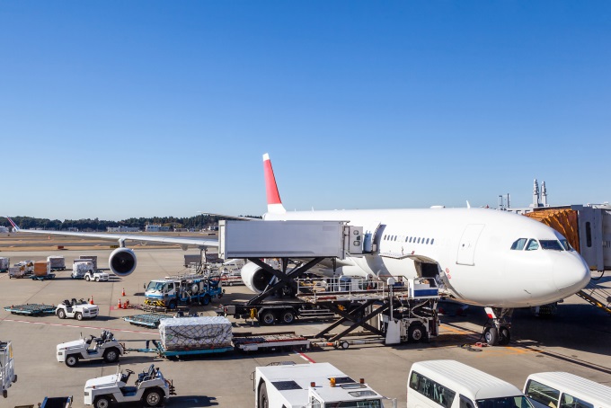 An airplane on a tarmac being loaded with cargo.